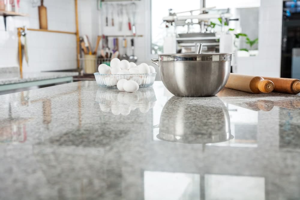 gray stone countertop with ingredients, bowl, and rolling pin